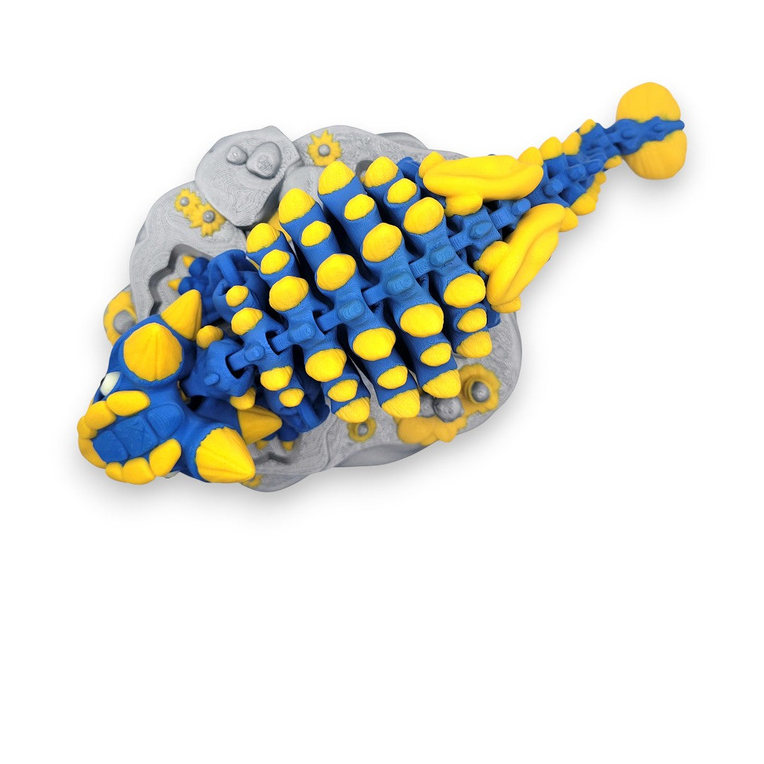 Rear view of the Skeleton Ankylosaurus showing its iconic tail club and articulated vertebrae over a rocky terrain base.