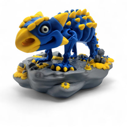 Articulated Skeleton Ankylosaurus 3D printed in blue and white PLA, shown in full side profile with spiked tail and fossil-style base.